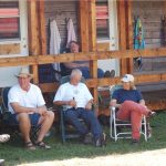 Family & friends relaxing in front of Ranchers' Row at Historic Reesor Ranch